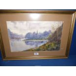 A framed and mounted watercolour depicting a river landscape with a Church spire peaking out of the