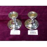 A pair of small silver weighted Candle holders, Birmingham 1929, makers S & Co,