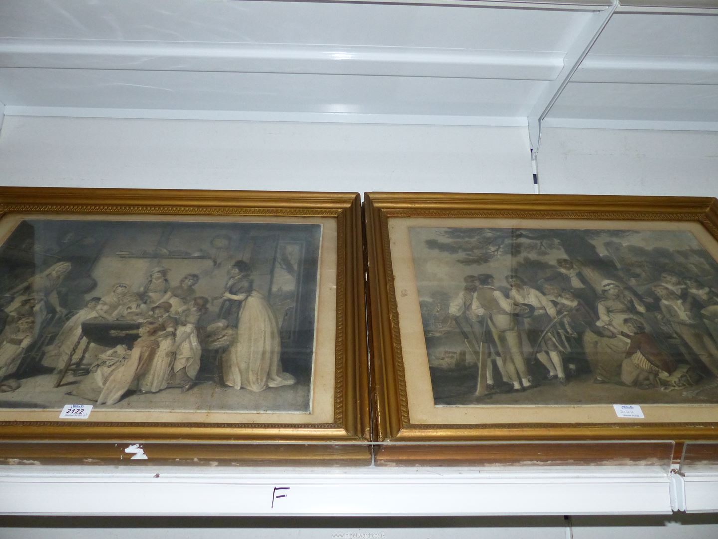 A pair of etchings in gilt frames.