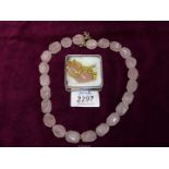 A rose quartz necklace with 925 silver clasp and one other with yellow metal chain.