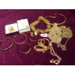 A box of vintage gold coloured metal jewellery to include; chokers, bangles, chains, etc.