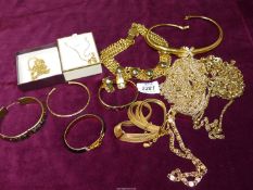 A box of vintage gold coloured metal jewellery to include; chokers, bangles, chains, etc.