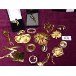 A quantity of yellow metal brooches including Givenchy, Monet, Trifari, Napier, etc.