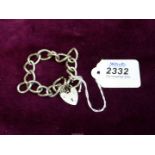 A large link silver Bracelet with heart shaped padlock clasp, 33 grams.