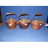 Three copper kettles, one marked G. H & C to base.