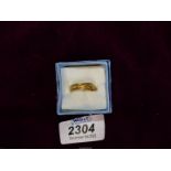 A 22ct gold wedding band with engraved detail, engraved inside '1909', makers S&W, size L 1/2.