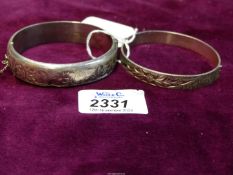 Two silver Bangles with scroll and floral designs, one with dent and safety chain broken,