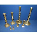 Four pairs of brass candlesticks including double helix design.