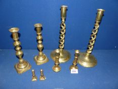 Four pairs of brass candlesticks including double helix design.