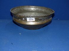 A heavy brass bowl with fluted rim.