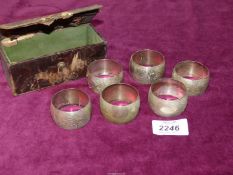 A cased set of six Napkin rings stamped 830 silver with floral detail.
