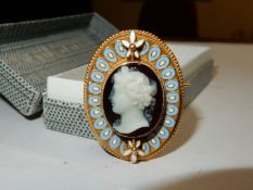 An unmarked gold set, hardstone Cameo brooch depicting a classical female head in a gold wirework,