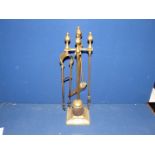 A brass companion set on stand.