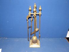 A brass companion set on stand.