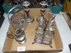 A pair of plated candlesticks, a cut glass and metal ice bucket, cruet set and a cream jug.