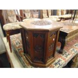 A carved eastern Teak octagonal cabinet a.