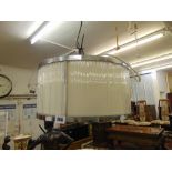 A contemporary glass rod drum shaped crystal chandelier