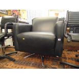 A black leather armchair on chrome legs,