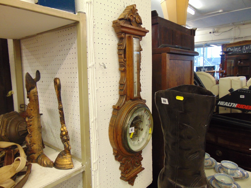 A carved Thermo/barometer,