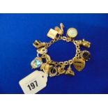 An early 1960's charm bracelet in 9ct Gold total weight 58 grams