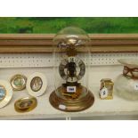 A brass and glass domed mantle clock working order
