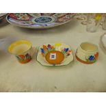 Three pieces of Clarice Cliff, Crocus pattern, pot has slight hairlines and tea cup some damage,