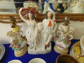 Two figural lamps and a Staffordshire flat back