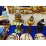 A glass oil lamp and a brass oil lamp,