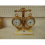 A brass mechanical clock/ barometer