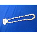 A large graduated cultured Baroque Peal necklace with 18ct Diamond set barrel clasp