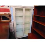 A White two door display cabinet