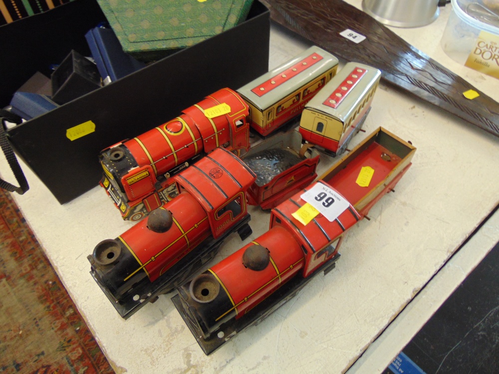 Three tin train models and four other pieces