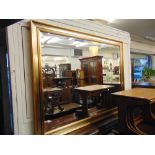 A large contemporary bevelled mirror