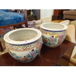 A pair of decorative fish bowls