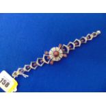 An 18ct White Gold Ruby and Diamond bracelet, 46 grams total weight, centre Ruby approx.