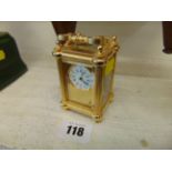 A miniature brass carriage clock,