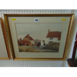 A gilt framed watercolour village scene