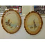 A pair of oval framed watercolour seascapes