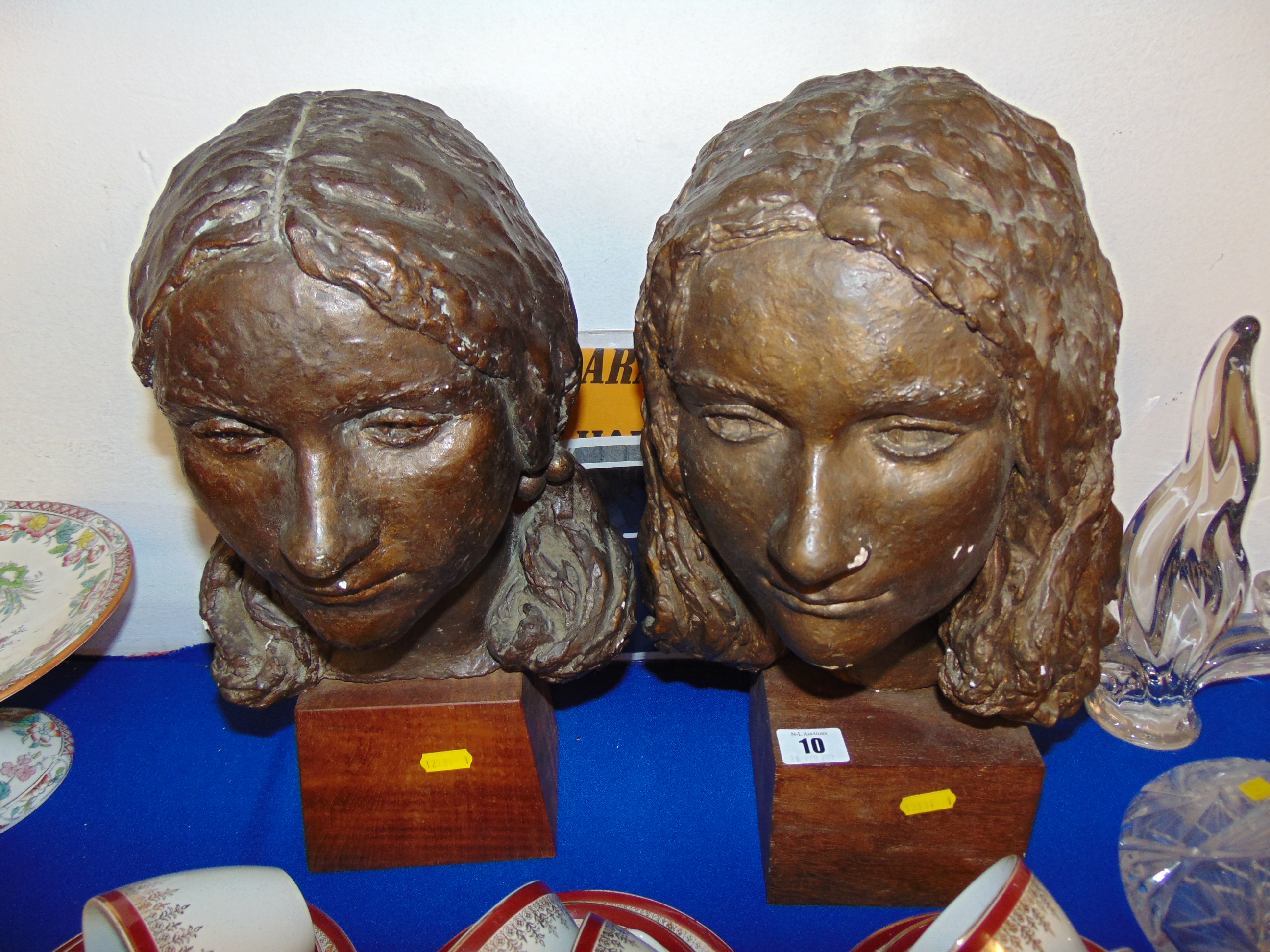Two sculptured ladies heads,
