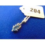 An 18ct White gold Diamond and blue Topaz pendant