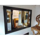 A contemporary black framed mirror