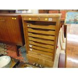 A tambour fronted oak printers cabinet