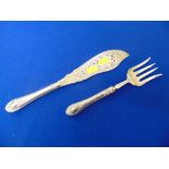 An ornate fish server, knife and fork,