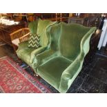 A pair of Victorian wing back armchairs