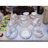A Twelve place Royal Doulton Sovereign tea set, gold and white, 12 plates, 12 saucers, 11 cups,
