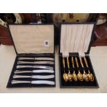 A boxed set of six Silver knives and a boxed gold plated teaspoons