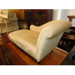 A cream upholstered chaise lounge,