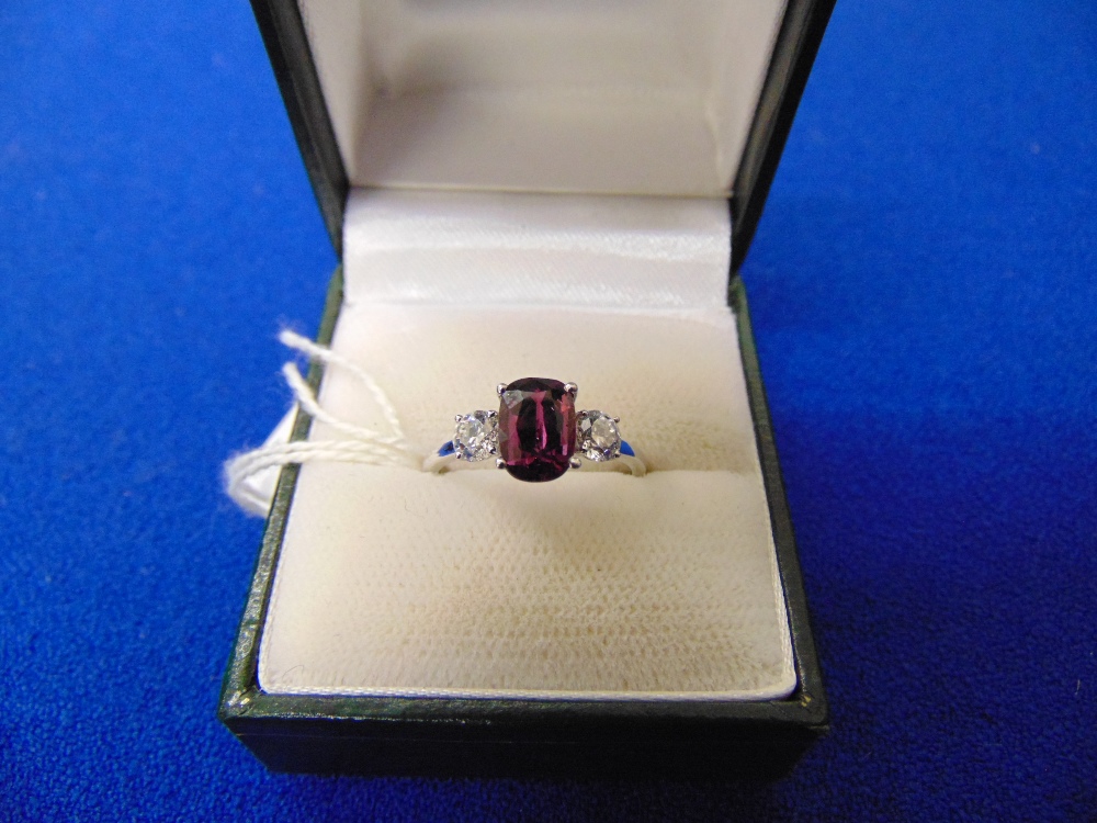 An 18ct White Gold, Sapphire (rare Amethyst Sapphire) and Diamond, three stone ring, centre stone . - Image 2 of 2