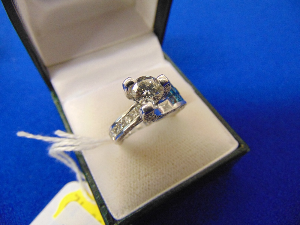 An 18ct White Gold Diamond cluster ring, with centre stone 90pts, total surrounding diamonds approx.