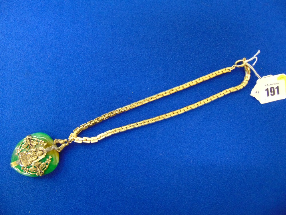 A large Heart shaped Jade pendant with a Buddha motif on a silver gilt chain